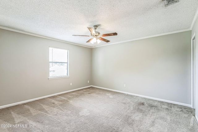 empty room with a textured ceiling, crown molding, ceiling fan, and light colored carpet