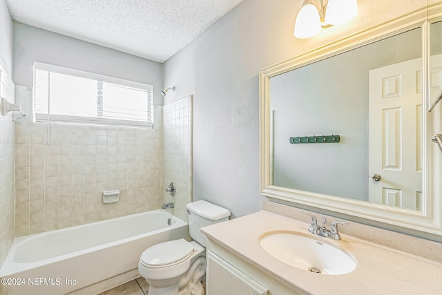 full bathroom featuring vanity, tiled shower / bath combo, toilet, and a textured ceiling