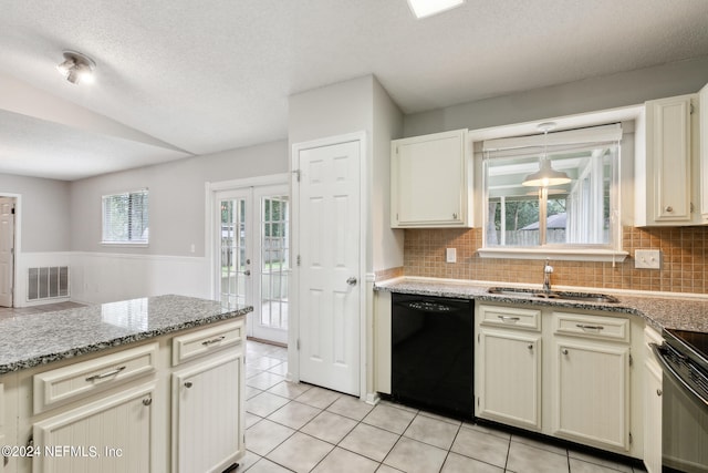 kitchen with black dishwasher, a textured ceiling, sink, decorative backsplash, and cream cabinets