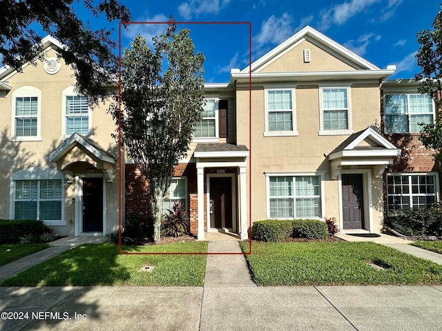 view of property with a front lawn