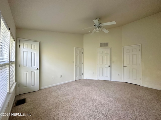 unfurnished bedroom featuring ceiling fan and carpet floors