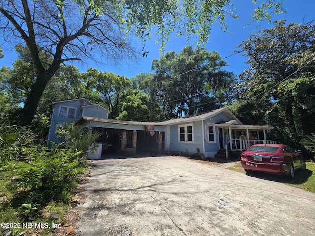 view of front of property with covered porch and a carport