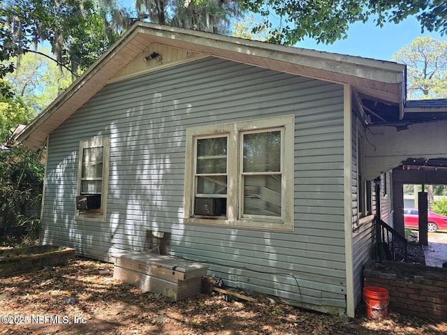 view of side of home featuring cooling unit