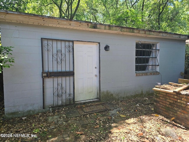 doorway to property with concrete block siding