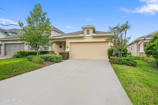 view of front facade with a front yard and a garage