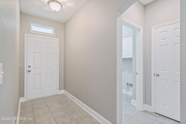 doorway featuring light tile patterned flooring