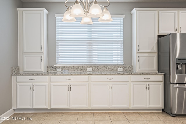 kitchen with stainless steel refrigerator with ice dispenser, white cabinetry, a chandelier, and light tile patterned floors