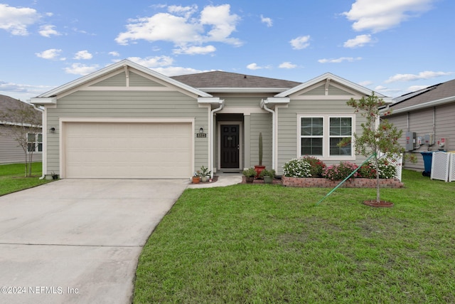 ranch-style house featuring a front lawn and a garage