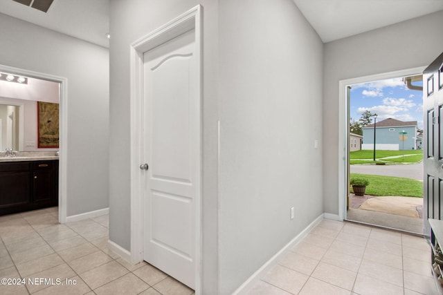 interior space with light tile patterned flooring and sink