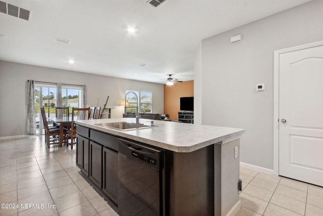 kitchen with a center island with sink, ceiling fan, stainless steel dishwasher, light tile patterned flooring, and sink