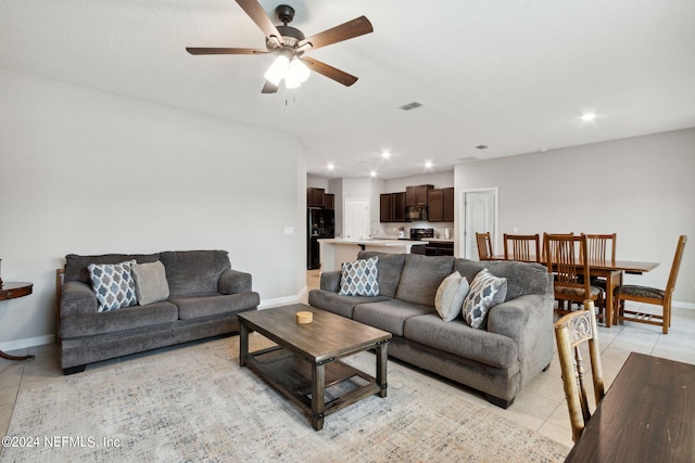 tiled living room with ceiling fan