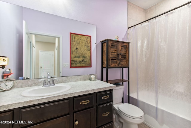 full bathroom featuring vanity, shower / bath combo with shower curtain, and toilet