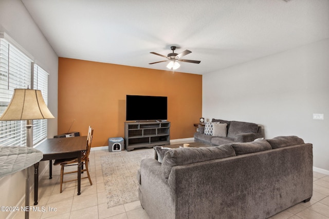 tiled living room featuring ceiling fan and plenty of natural light