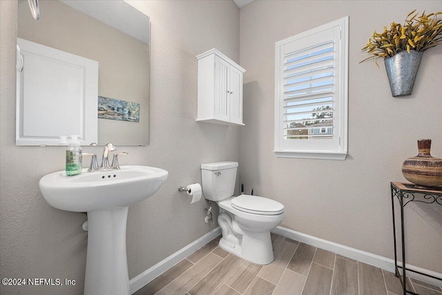 bathroom featuring hardwood / wood-style floors and toilet