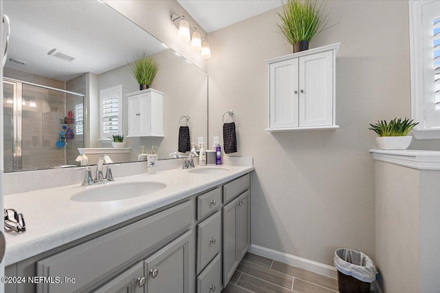 bathroom with vanity and an enclosed shower