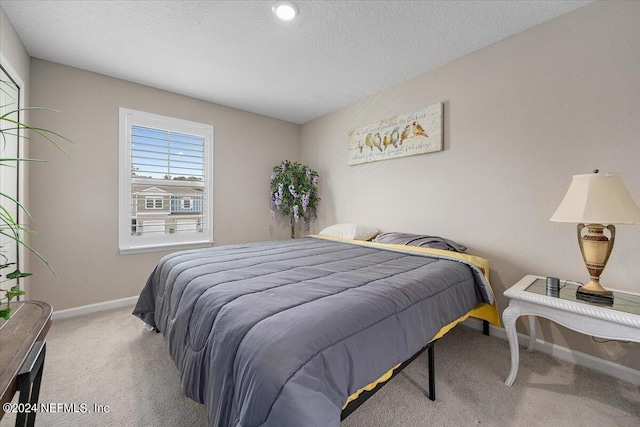 carpeted bedroom featuring a textured ceiling