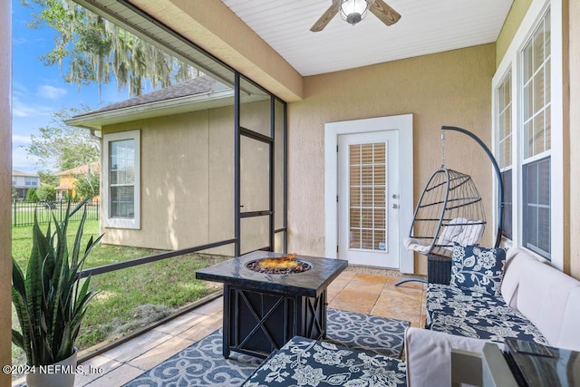 sunroom featuring ceiling fan