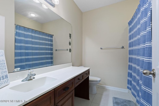 bathroom with toilet, tile patterned flooring, vanity, and curtained shower