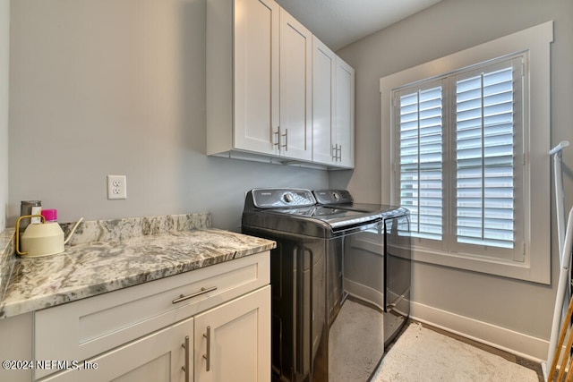 laundry area featuring cabinets and washing machine and clothes dryer