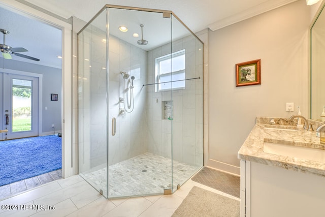 bathroom featuring walk in shower, vanity, ornamental molding, and ceiling fan