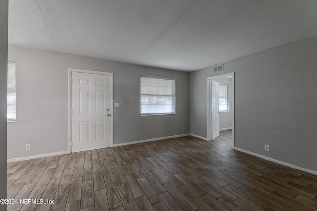 1340 W 11th St, Jacksonville, FL 32209 - unfurnished living room featuring visible vents, baseboards, and wood finished floors
