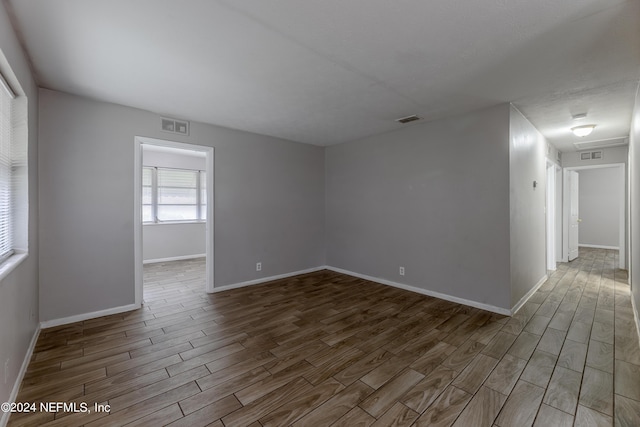 1340 W 11th St, Jacksonville, FL 32209 - empty room with baseboards, visible vents, and wood finished floors