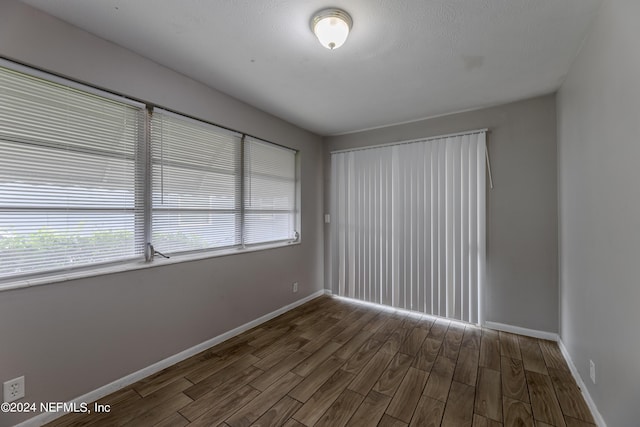 1340 W 11th St, Jacksonville, FL 32209 - unfurnished room featuring baseboards and dark wood finished floors