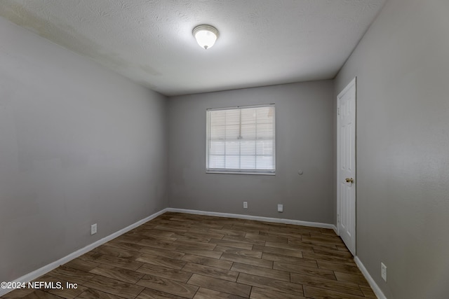1340 W 11th St, Jacksonville, FL 32209 - unfurnished room featuring baseboards, wood finished floors, and a textured ceiling