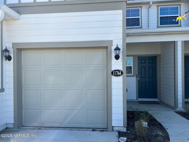 doorway to property with a garage