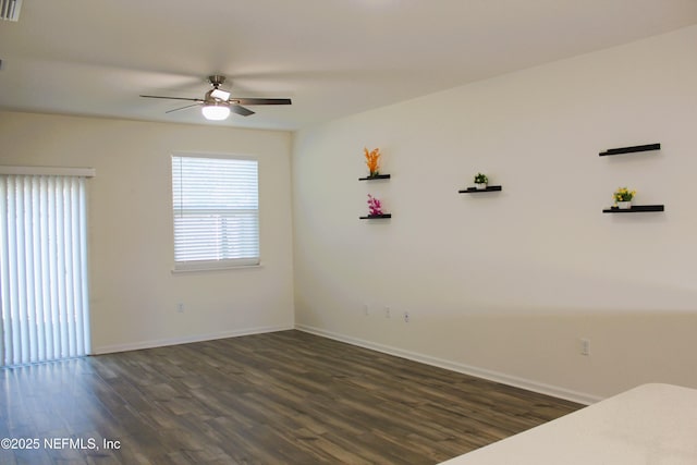 empty room featuring ceiling fan and dark hardwood / wood-style flooring