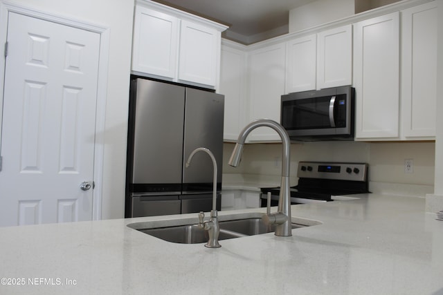 kitchen with white cabinets, stainless steel appliances, and sink