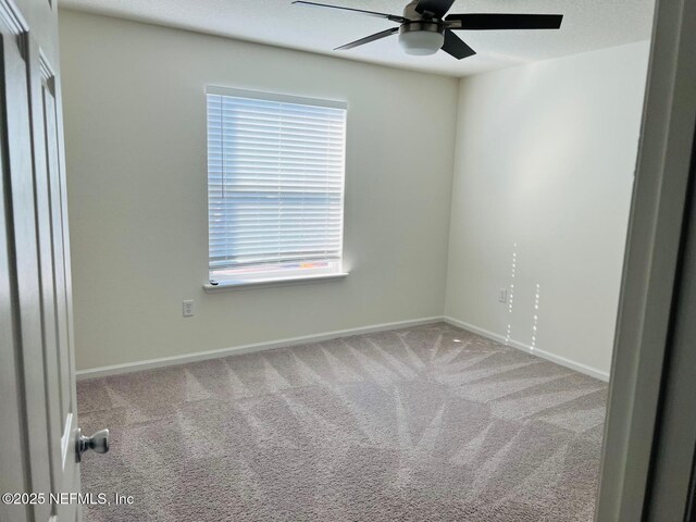 spare room with carpet floors and ceiling fan