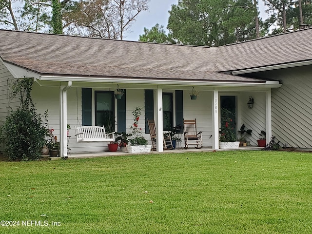 exterior space featuring a yard and covered porch