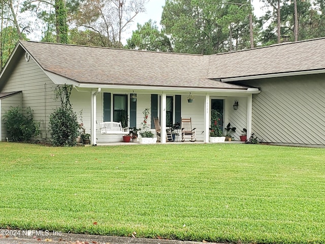 exterior space with a lawn and covered porch