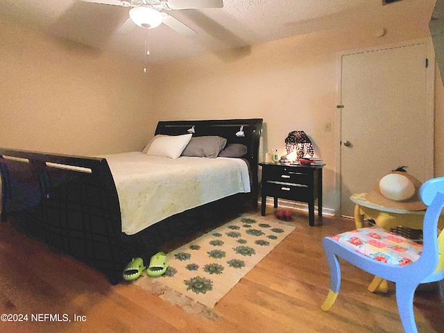 bedroom featuring ceiling fan and hardwood / wood-style flooring