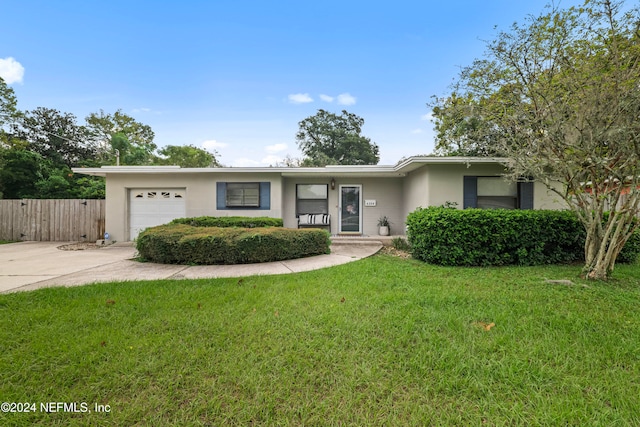 ranch-style home with a front lawn and a garage