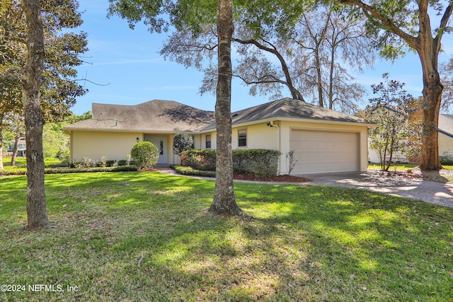 single story home featuring a front yard and a garage