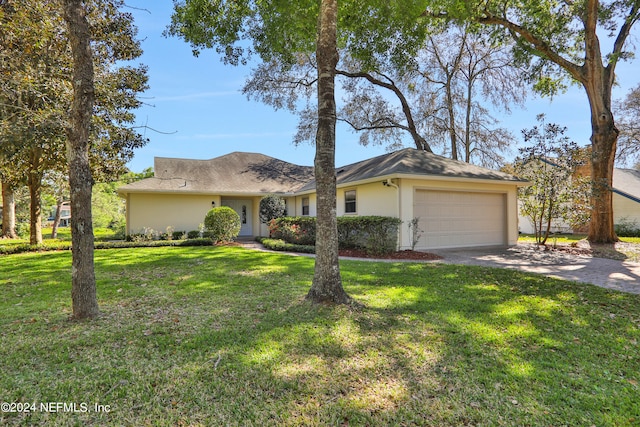 single story home featuring a front lawn and a garage