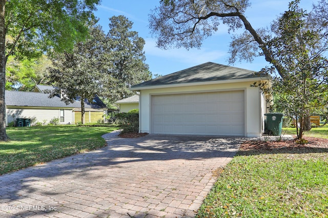 garage featuring a lawn