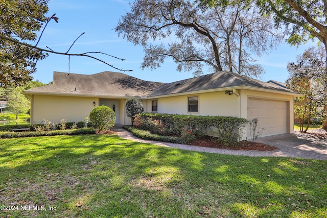 ranch-style home with a front yard and a garage