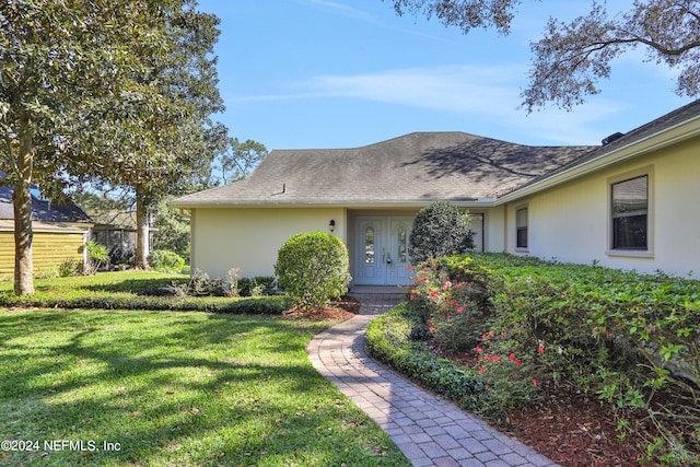 ranch-style home with a front lawn