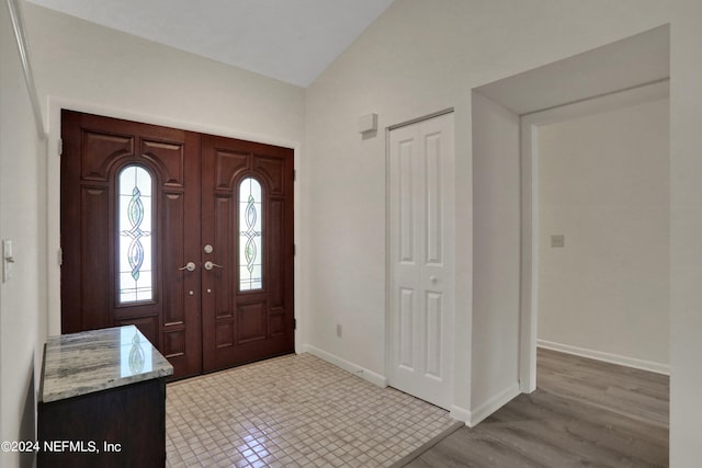 entrance foyer with light wood-type flooring and lofted ceiling