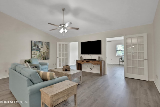 living room featuring wood-type flooring, lofted ceiling, and ceiling fan