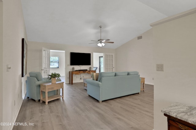 living room with light wood-type flooring, lofted ceiling, and ceiling fan