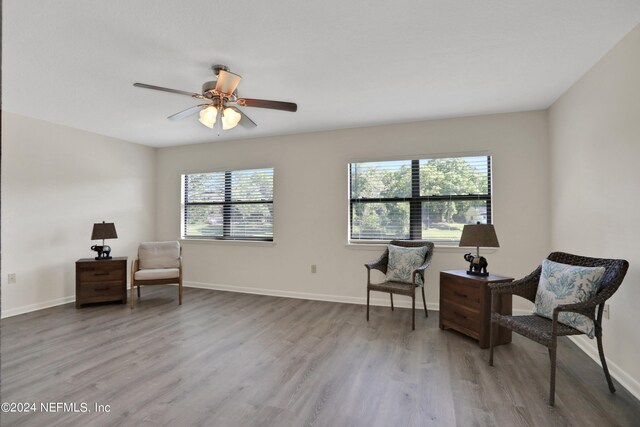 living area with light hardwood / wood-style floors and ceiling fan