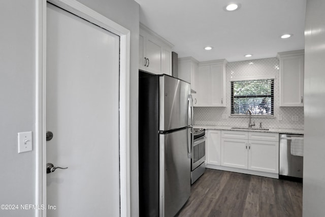 kitchen with sink, white cabinets, stainless steel appliances, backsplash, and dark hardwood / wood-style flooring