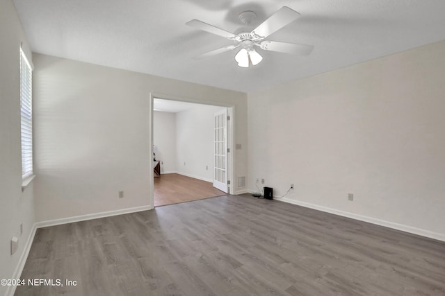 empty room with ceiling fan and hardwood / wood-style floors