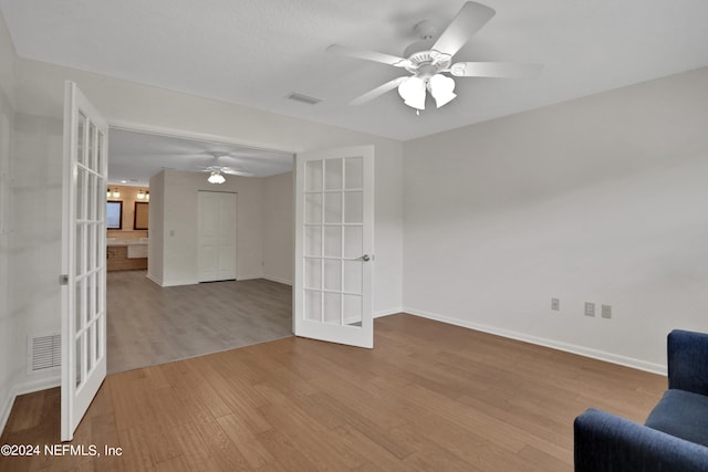 interior space featuring light hardwood / wood-style floors, ceiling fan, and french doors