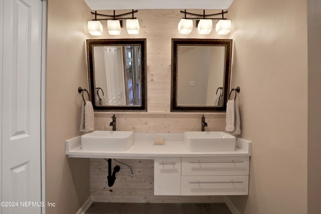 bathroom with vanity and wood walls