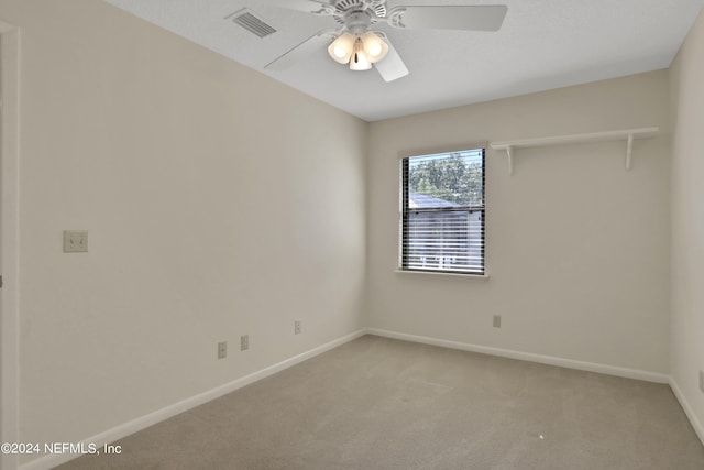 unfurnished room featuring ceiling fan and light colored carpet